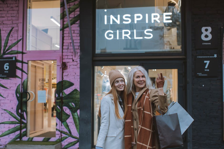 Mother and daughter enjoy a shopping day together, smiling in front of a trendy store.