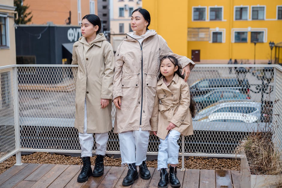 Stylish family in beige coats posing outdoors. Emphasizing fashion and unity.